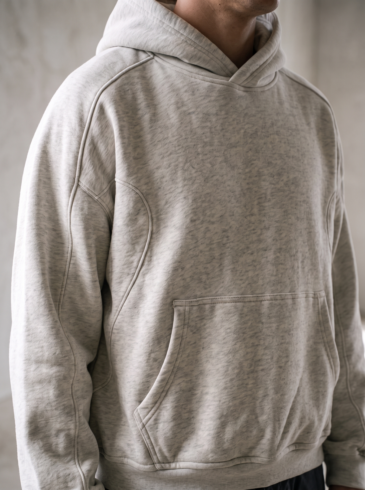 Grey marle heavyweight cropped hoodie worn by a model, close up on the cropped fit