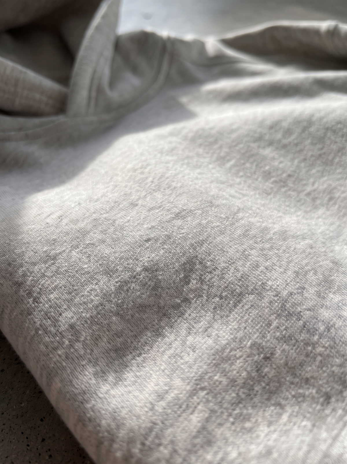 Close up of smooth grey marle heavyweight cotton fleece