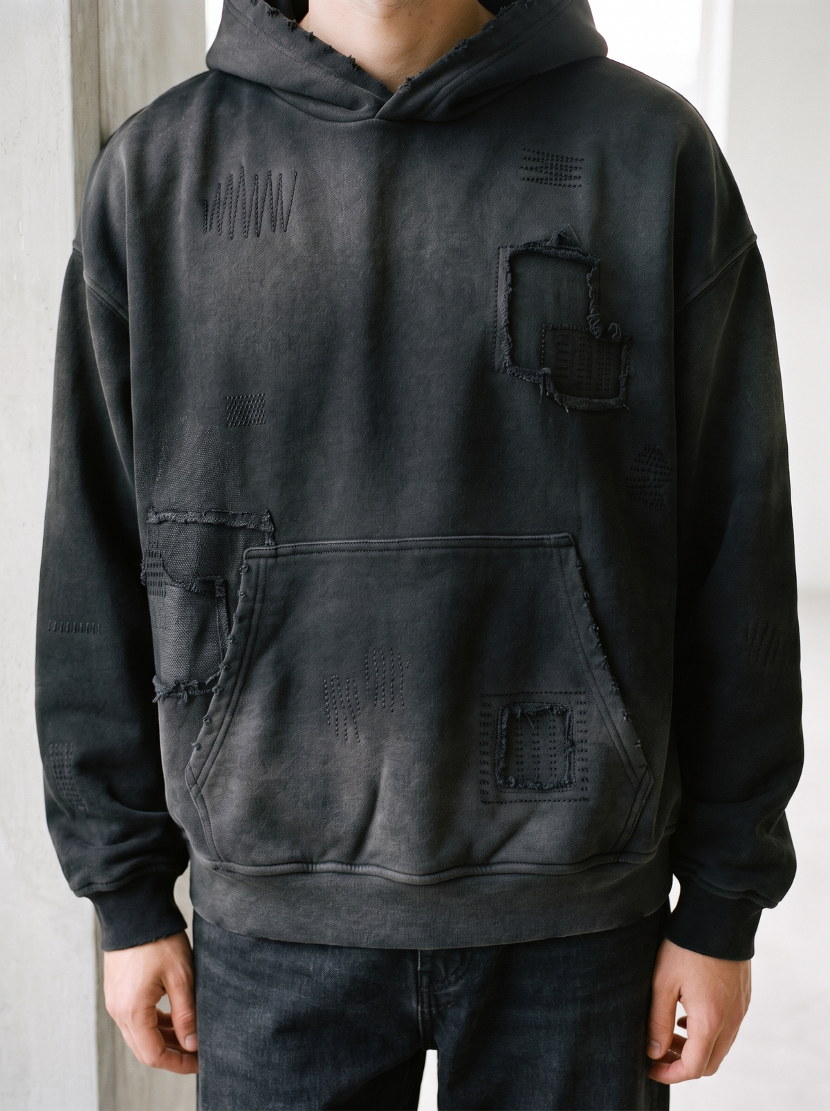 Sashiko stitched hoodie worn by a model, close up on the stitchwork