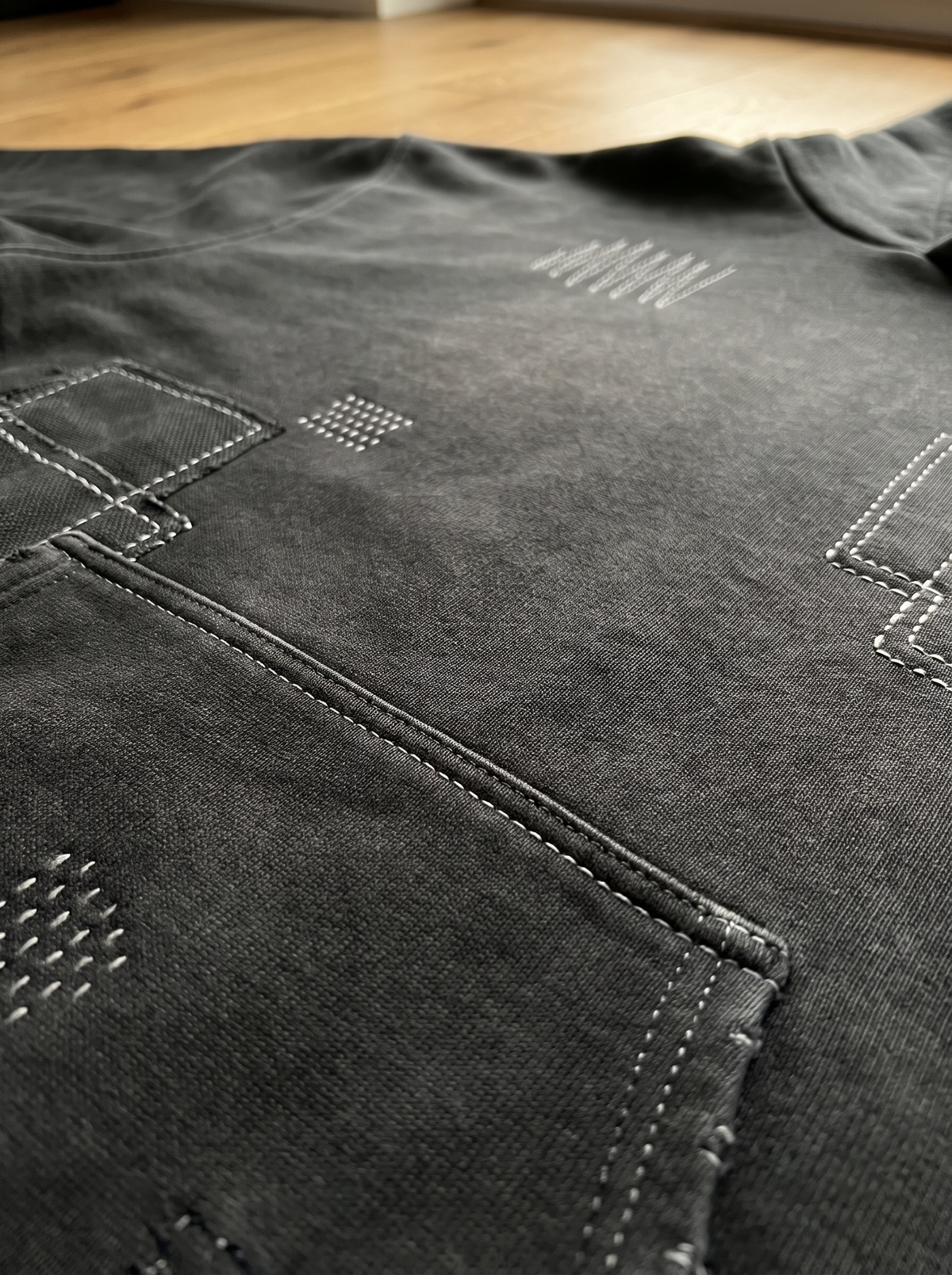 Close up of the sunfaded French terry and sashiko stitching