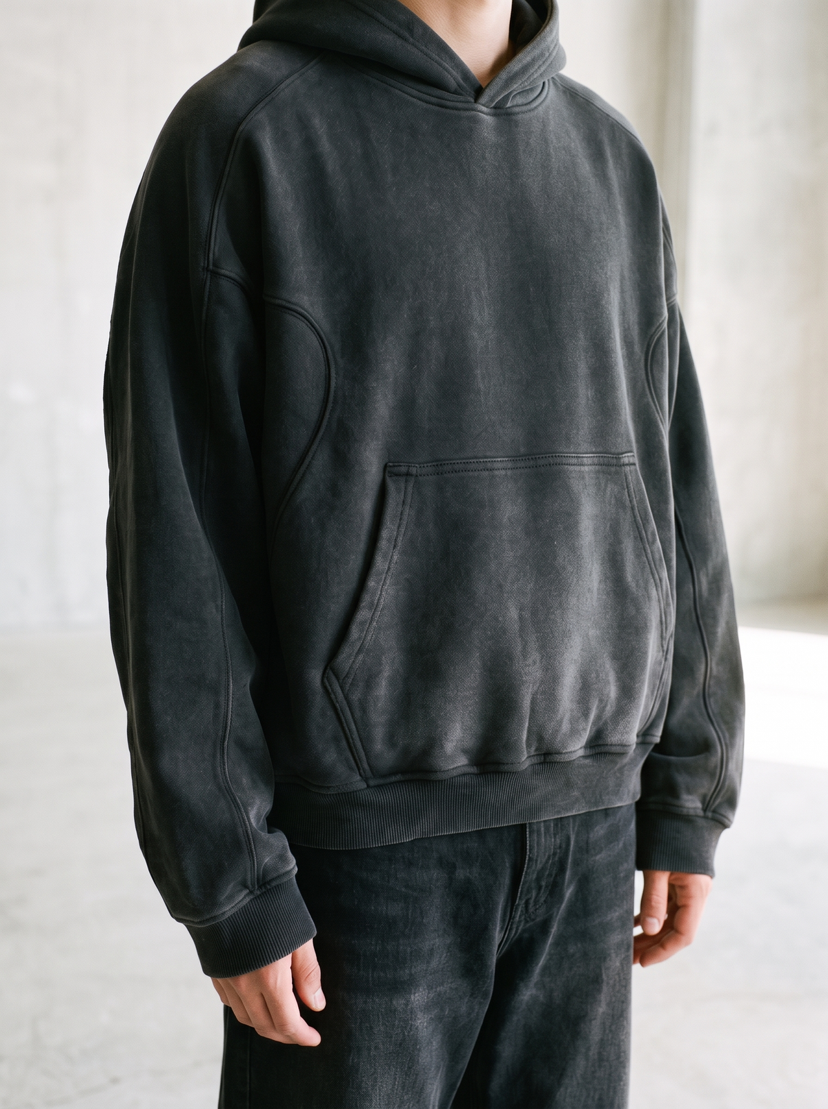 Washed heavyweight cropped hoodie worn by a model, close up on the cropped fit