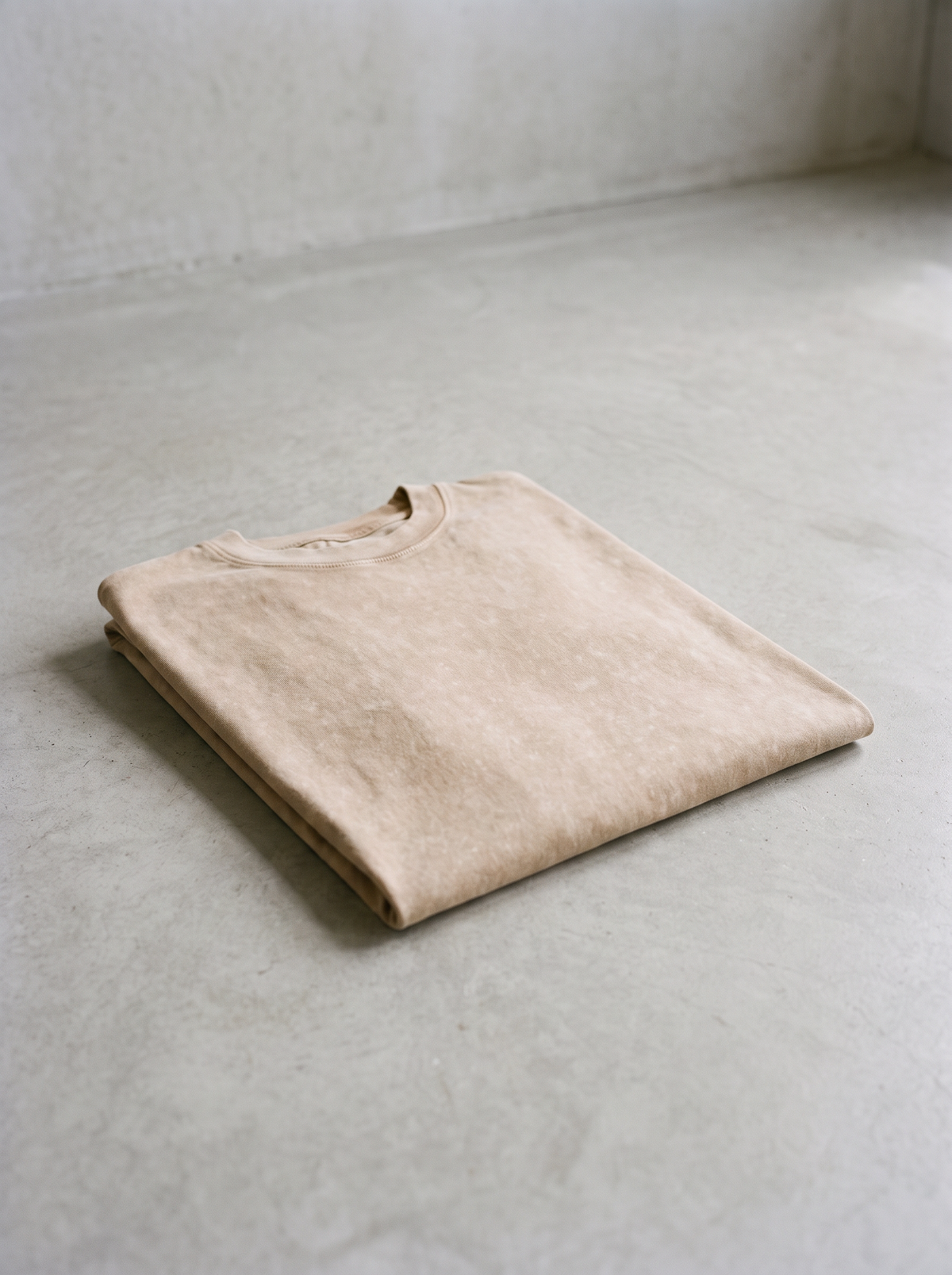 230GSM Vintage Faded Washed T-Shirt folded on concrete
