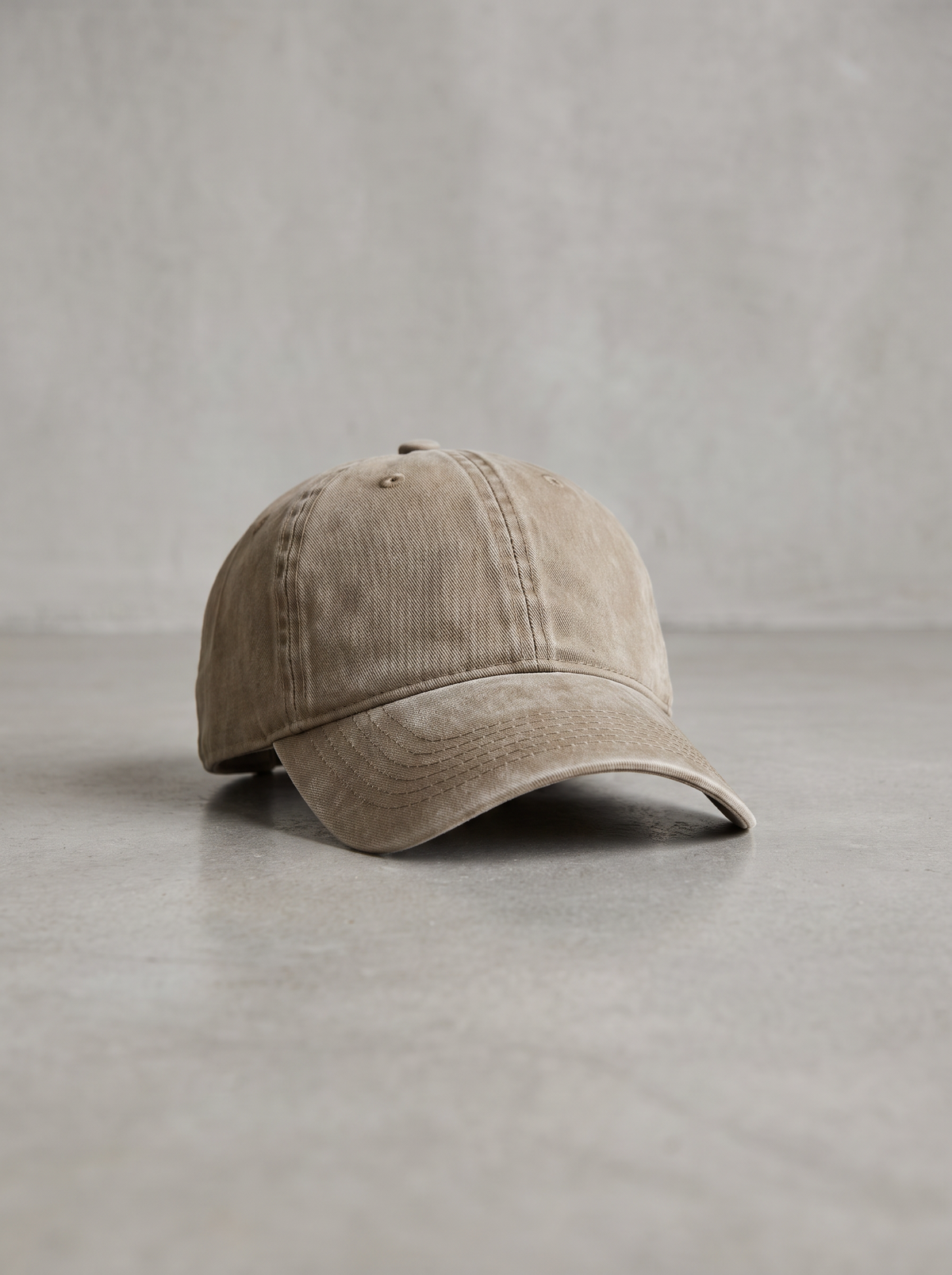 Khaki washed vintage baseball cap on a concrete floor